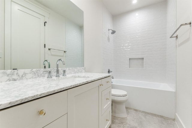 full bathroom with vanity, tiled shower / bath, and toilet