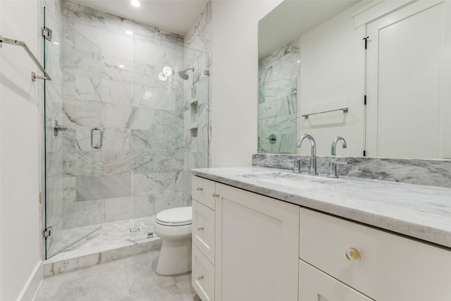 bathroom with vanity, a shower with shower door, and toilet