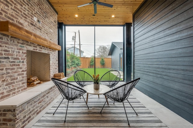 sunroom featuring wooden ceiling and ceiling fan