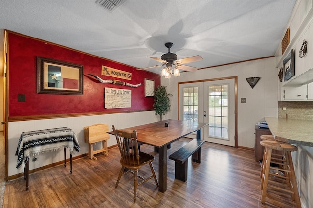 dining room featuring ceiling fan, wood-type flooring, french doors, and a textured ceiling