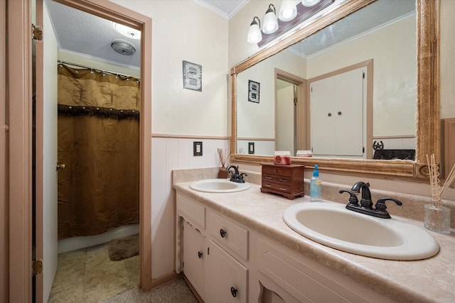 bathroom with vanity, crown molding, and walk in shower