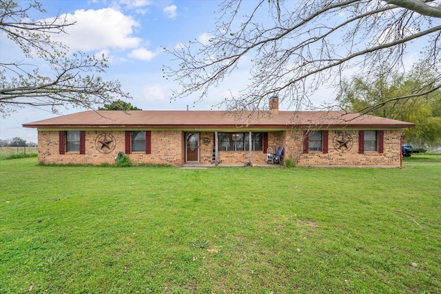 ranch-style home featuring a front yard