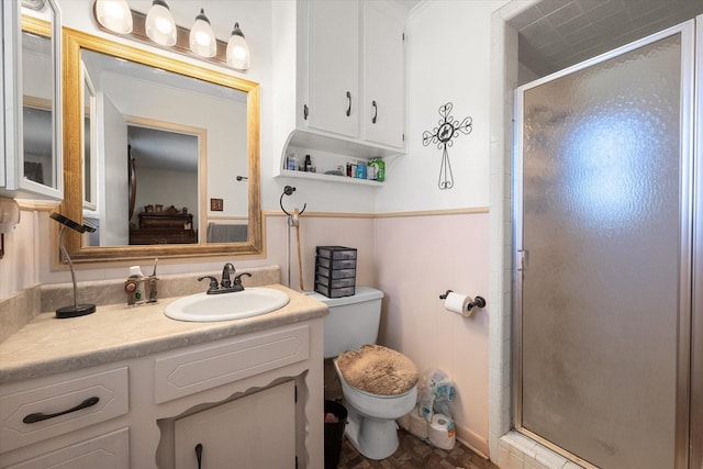 bathroom featuring walk in shower, vanity, and toilet