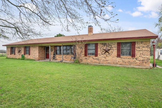 back of property featuring a lawn