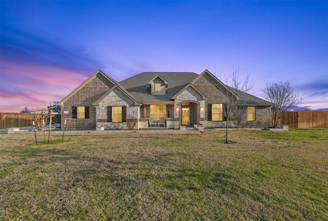 view of front of house with a yard and a patio area