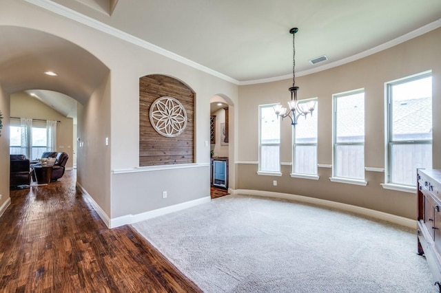 401 Devonshire Dr, Prosper, TX 75078 - unfurnished dining area with arched walkways, a chandelier, crown molding, and wood finished floors