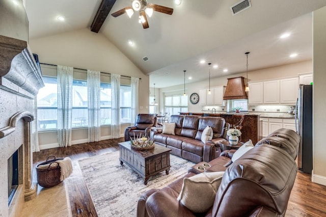 401 Devonshire Dr, Prosper, TX 75078 - living area featuring ceiling fan, beam ceiling, light wood finished floors, a stone fireplace, and recessed lighting