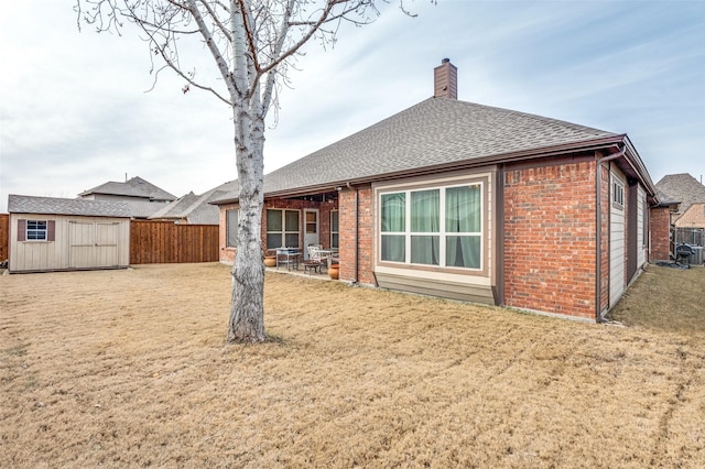 401 Devonshire Dr, Prosper, TX 75078 - rear view of property featuring brick siding, a chimney, a shingled roof, and a patio