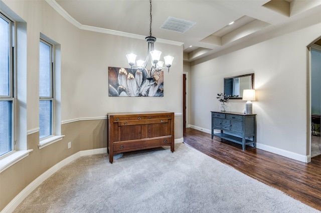 interior space featuring crown molding, dark hardwood / wood-style floors, and a chandelier