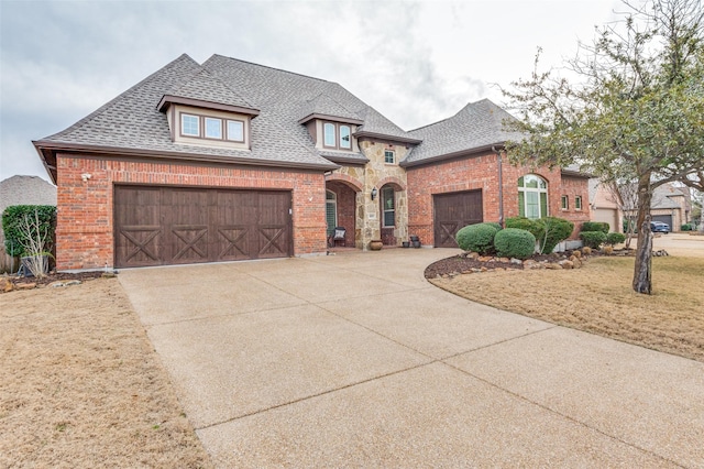 401 Devonshire Dr, Prosper, TX 75078 - french country style house with brick siding, a shingled roof, concrete driveway, and an attached garage
