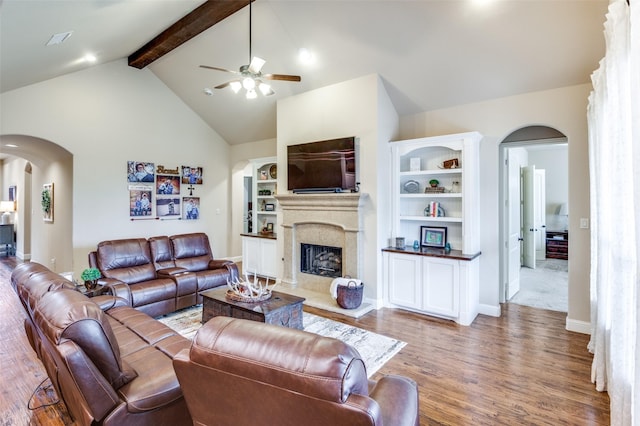 401 Devonshire Dr, Prosper, TX 75078 - living room featuring arched walkways, a ceiling fan, wood finished floors, and a fireplace
