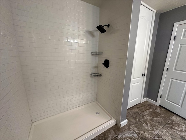 bathroom with a tile shower