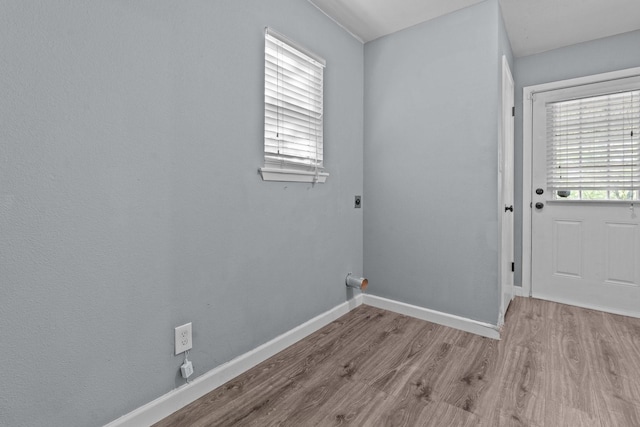 119 Wheeler St, Weatherford, TX 76086 - washroom featuring laundry area, hookup for an electric dryer, wood finished floors, and baseboards