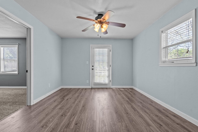 119 Wheeler St, Weatherford, TX 76086 - empty room featuring wood finished floors, ceiling fan, and baseboards