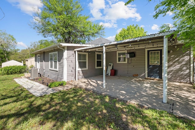 119 Wheeler St, Weatherford, TX 76086 - back of property featuring a yard, central AC unit, an attached carport, and a patio