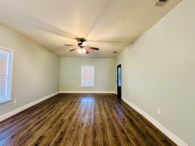 spare room featuring dark hardwood / wood-style floors and ceiling fan