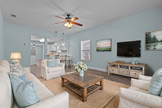 119 Wheeler St, Weatherford, TX 76086 - living area with wood finished floors, ceiling fan, baseboards, and visible vents