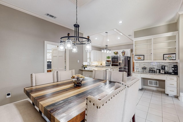 dining space with ornamental molding and light tile patterned flooring