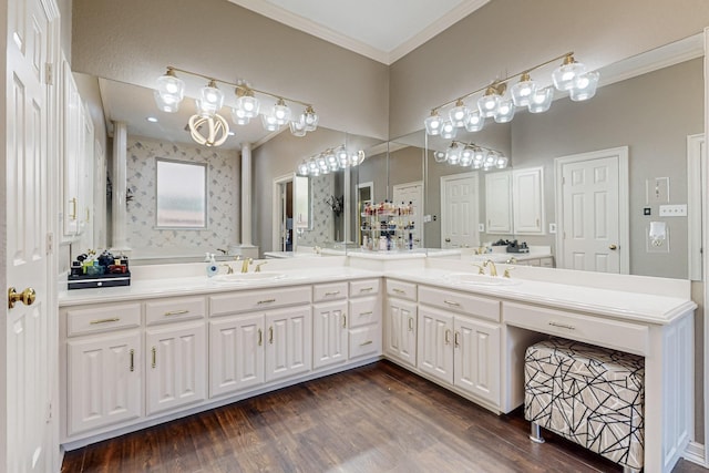 bathroom with ornamental molding, hardwood / wood-style floors, and vanity