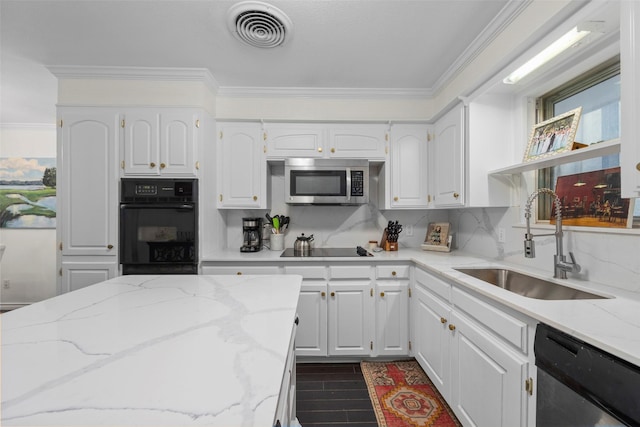 kitchen featuring sink, black appliances, white cabinets, and light stone countertops