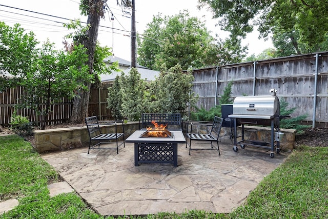 view of patio with grilling area and an outdoor fire pit