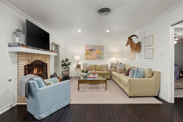 living room with dark hardwood / wood-style flooring, crown molding, and a fireplace