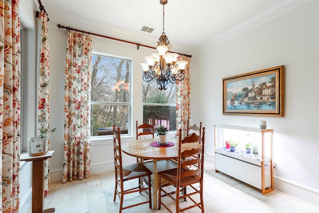 dining space featuring a notable chandelier and crown molding