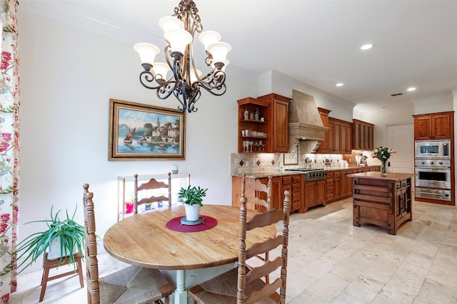 dining area featuring crown molding and a chandelier