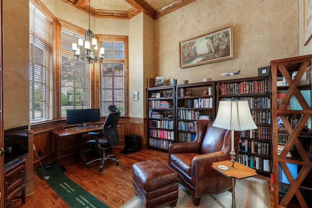 office featuring an inviting chandelier, crown molding, hardwood / wood-style floors, and a high ceiling