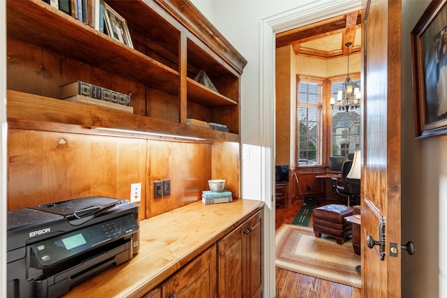 office space with an inviting chandelier and dark wood-type flooring