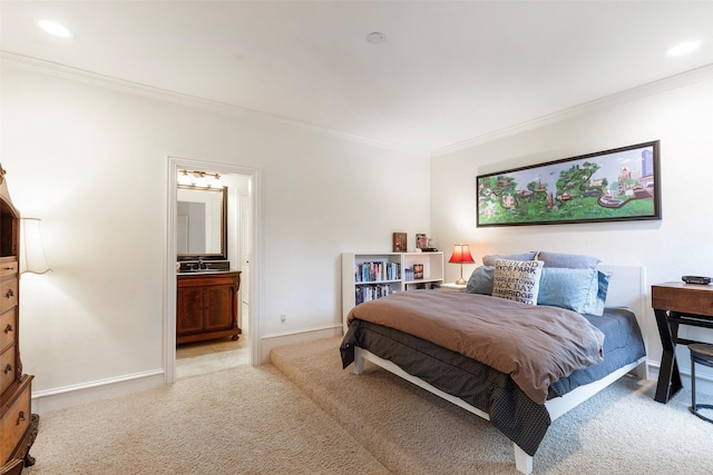 bedroom featuring crown molding, connected bathroom, and light carpet