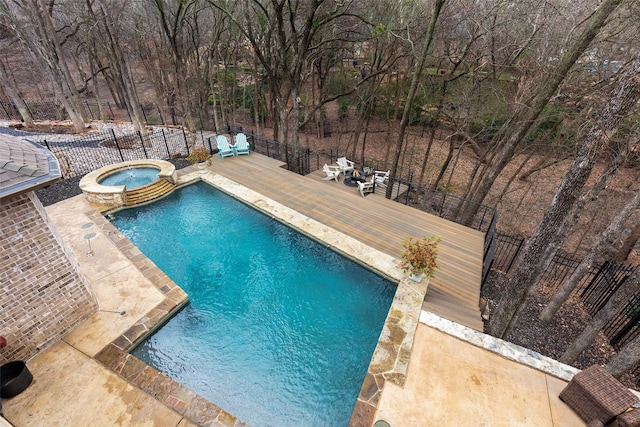 view of pool with an in ground hot tub and a wooden deck