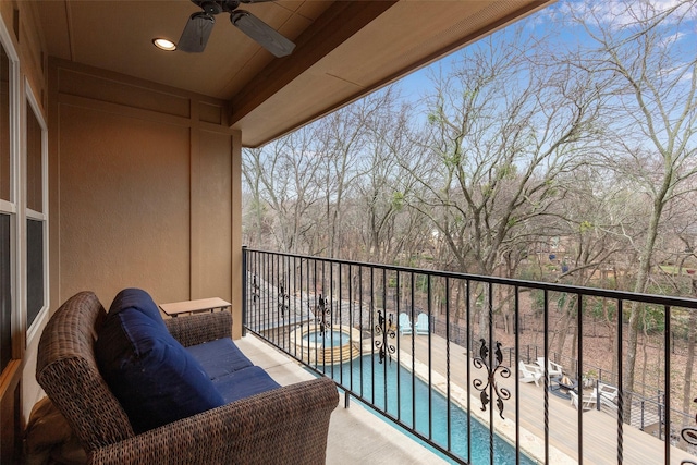 balcony with an in ground hot tub, ceiling fan, an outdoor living space, and a patio area