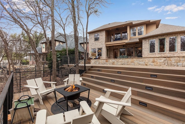 wooden deck with an outdoor fire pit