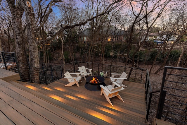 deck at dusk with a fire pit