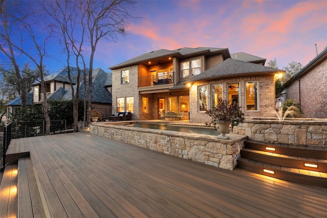 deck at dusk featuring a patio