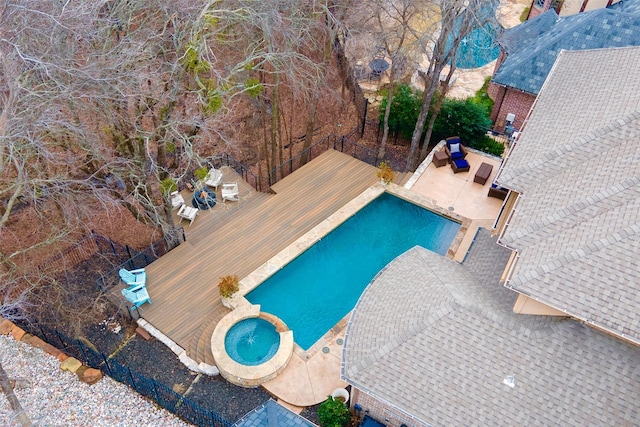 view of pool featuring a wooden deck, an in ground hot tub, and a patio