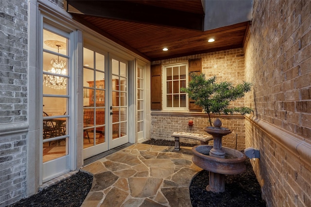 sunroom with wood ceiling and french doors