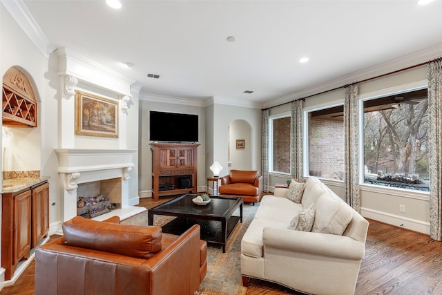 living room featuring ornamental molding and wood-type flooring