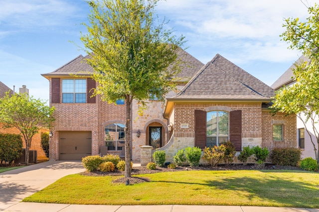 view of front of property with a garage and a front lawn