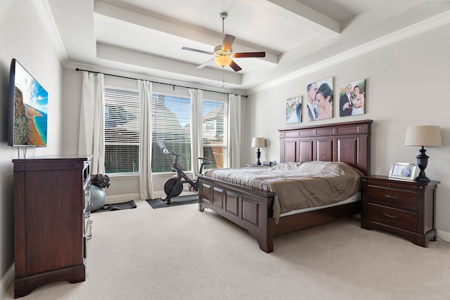 bedroom featuring ceiling fan, light colored carpet, ornamental molding, and a raised ceiling