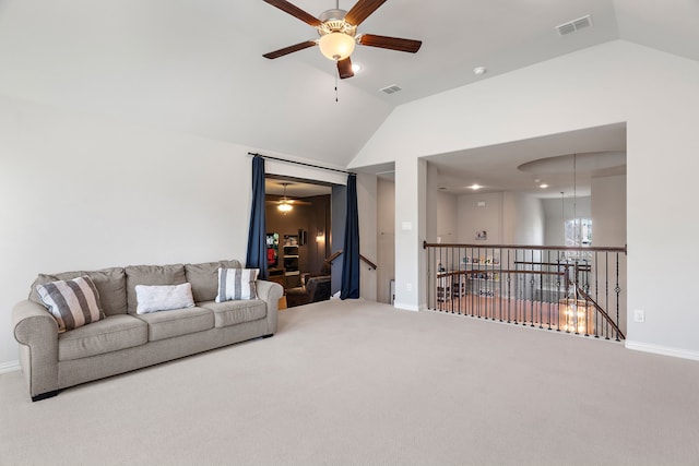 living room featuring vaulted ceiling, carpet floors, and ceiling fan with notable chandelier