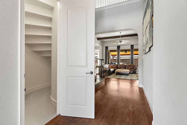 hall with beamed ceiling and dark hardwood / wood-style floors