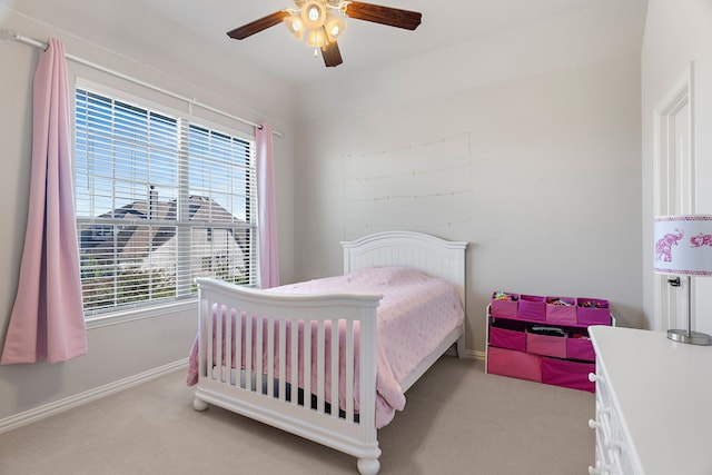 bedroom featuring light colored carpet and ceiling fan