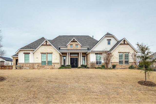 3316 Dovehill Dr, Northlake, TX 76247 - view of front facade with board and batten siding, a standing seam roof, a shingled roof, stone siding, and metal roof