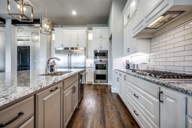 3316 Dovehill Dr, Northlake, TX 76247 - kitchen with a sink, built in appliances, light stone counters, premium range hood, and dark wood finished floors