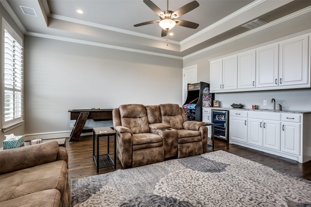 3316 Dovehill Dr, Northlake, TX 76247 - living area featuring wine cooler, wet bar, dark wood-style floors, a tray ceiling, and ornamental molding