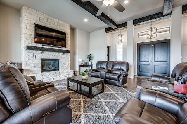 living room with beamed ceiling, ceiling fan, hardwood / wood-style floors, and a fireplace