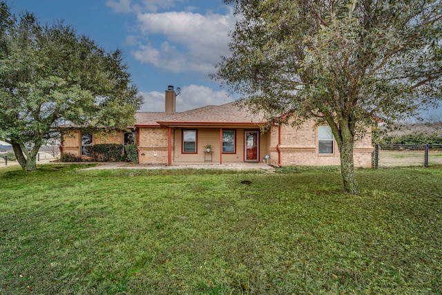 rear view of house featuring a lawn