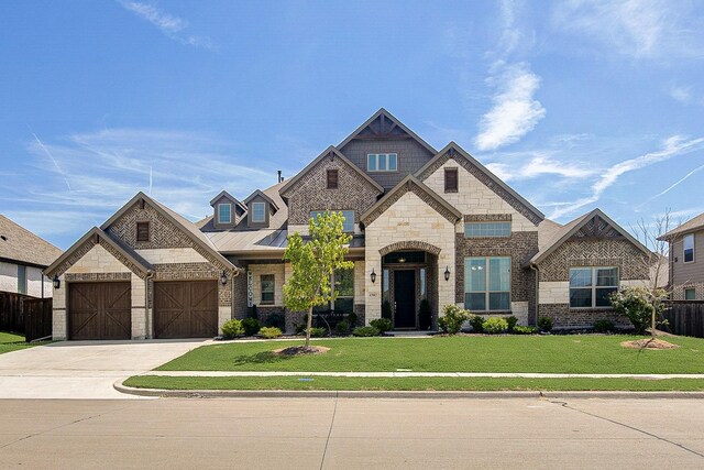 view of front of property with a garage and a front yard